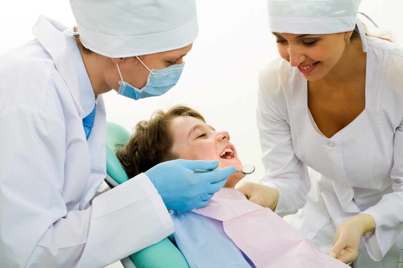 two dentists performing dental procedure on a patient