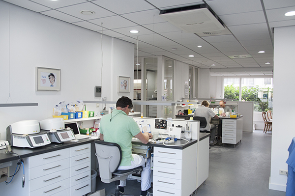 Man working in a dental lab with dental air purifier installed