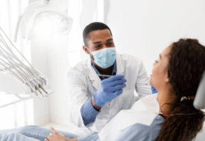 Male dentist making treatment on a patient with the best air purifier for dental clinic installed